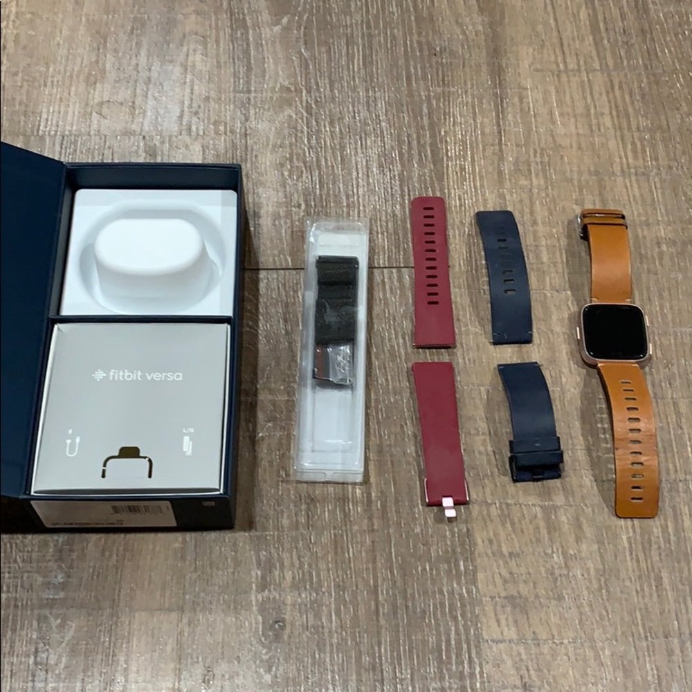 fitbit versa (rose gold) with 4 bands